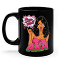 Black ceramic coffee mug featuring an AKA-inspired cartoon woman with long black hair, pearl earrings, and a pink dress. The design includes a comic-style speech bubble that says "Skee-wee!!!" above bold pink and green AKA lettering, creating a fun sorority-inspired coffee mug gift for members and supporters.