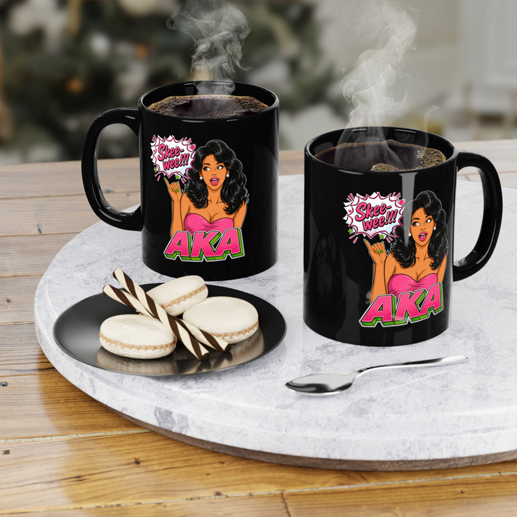 Black ceramic coffee mug featuring an AKA-inspired cartoon woman with long black hair, pearl earrings, and a pink dress. The design includes a comic-style speech bubble that says "Skee-wee!!!" above bold pink and green AKA lettering, creating a fun sorority-inspired coffee mug gift for members and supporters.